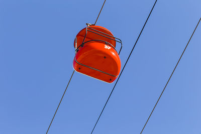 Low angle view of lantern against clear blue sky