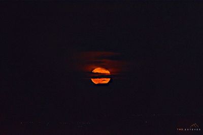 Illuminated orange sky at night