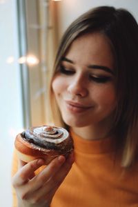 Close-up of woman looking at pastry