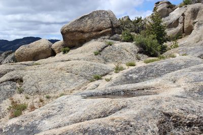 Low angle view of rock formation against sky