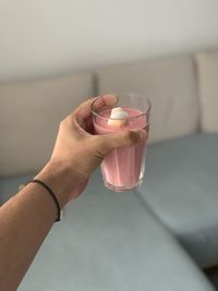 Midsection of woman drinking glass with water