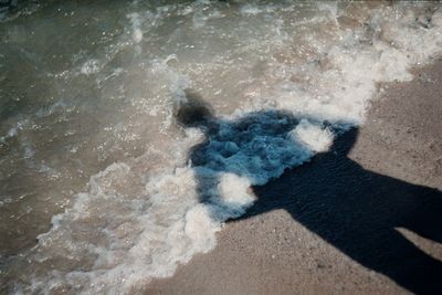 Shadow of hand on water