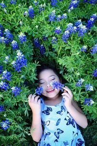 Portrait of a smiling girl standing against plants