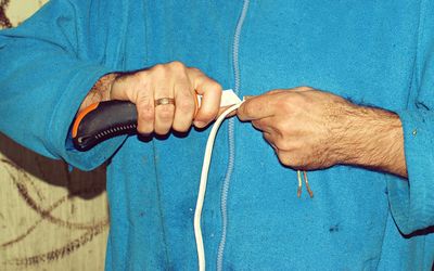 Midsection of man holding rope