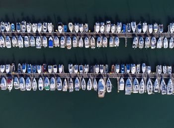 Panoramic aerial view on boats moored in the pier, drone shot directly above. luanco in asturias