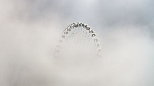 Low angle view of ferris wheel against sky