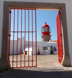 Red tower on building against sky