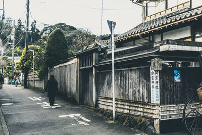 Rear view of woman walking on built structure