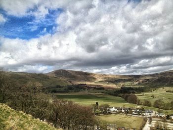 Scenic view of landscape against cloudy sky