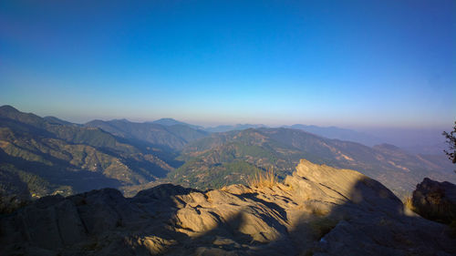 Scenic view of dramatic landscape against clear blue sky