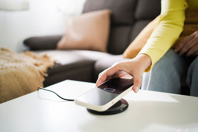 Midsection of woman using mobile phone