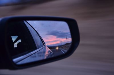 Reflection of car on side-view mirror