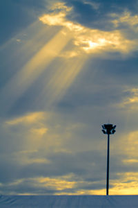 Low angle view of street light against sky during sunset