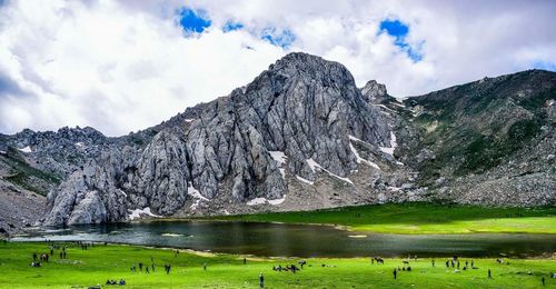 Scenic view of lake against cloudy sky