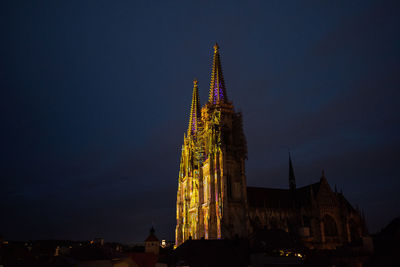 Low angle view of illuminated building against sky at night