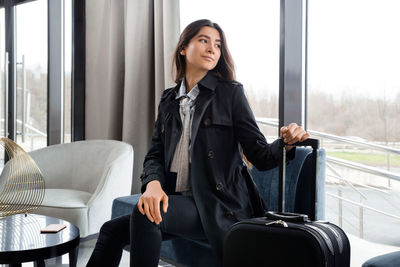 Woman sitting on sofa at restaurant