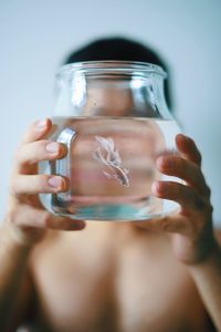 Close-up of woman holding glass jar