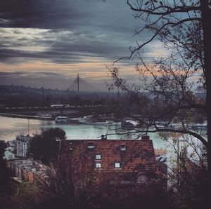 View of cityscape against cloudy sky