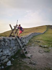 Female hiker on the mourne wall