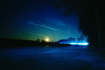 Scenic view of illuminated rainbow against sky at night