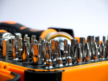 Close-up of drill bits against white background