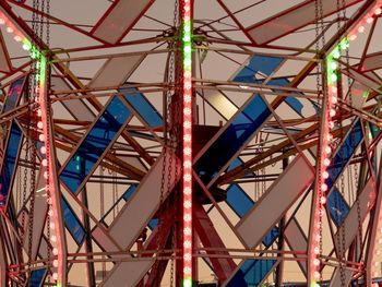 Low angle view of ferris wheel against clear blue sky