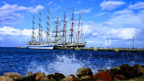 Sailboats in sea against sky