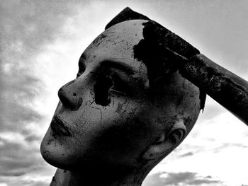 Close-up of rusty sculpture against sky