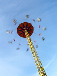 Low angle view of amusement park ride against sky