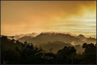 Scenic view of mountains against sky at sunset