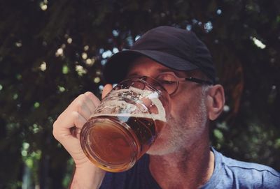 Midsection of man drinking beer glass