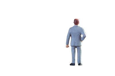 Rear view of man walking against white background