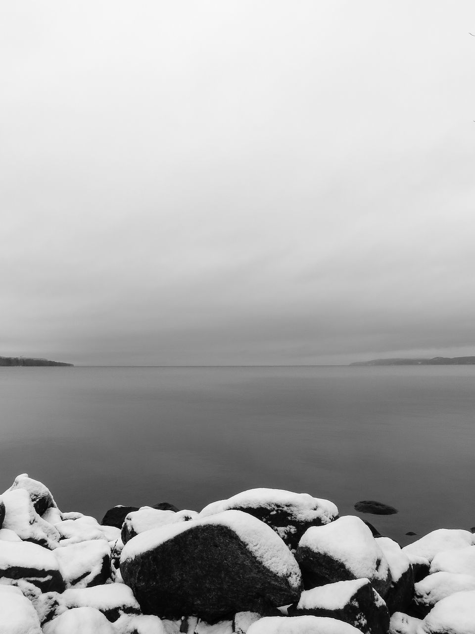 tranquil scene, water, scenics, tranquility, sea, beauty in nature, nature, horizon over water, sky, weather, idyllic, copy space, rock - object, remote, non-urban scene, shore, calm, winter, fog, outdoors