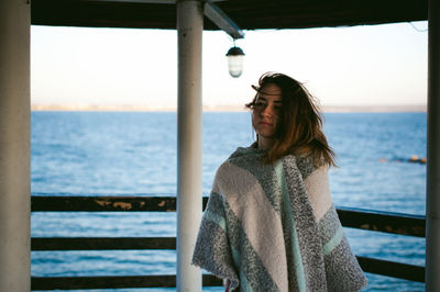 Close-up of young woman standing at beach