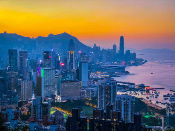 High angle view of illuminated buildings against sky during sunset