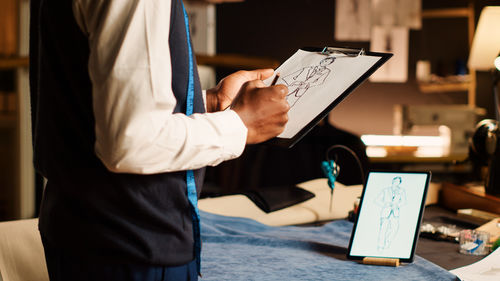 Midsection of man working in office