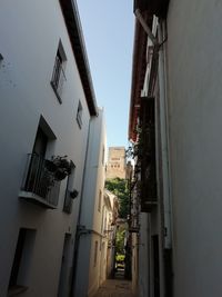 Street amidst buildings against clear sky