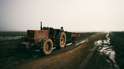 A lone tractor on a muddy farm road at dawn somewhere in knysna.