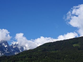 Scenic view of mountains against blue sky