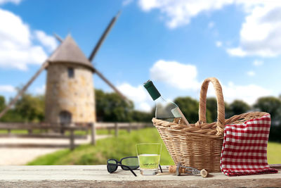 Wicker basket on table against sky