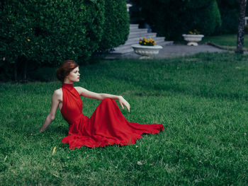 Young woman on grass in field