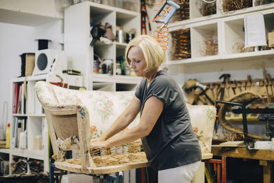 Female entrepreneur making sofa in workshop