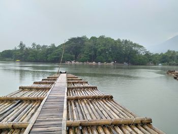 Pier over lake against sky