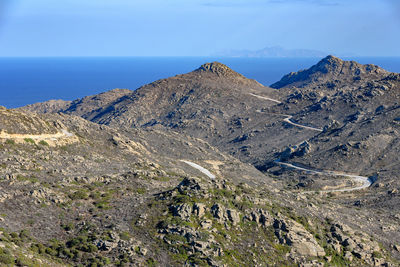 Scenic view of mountains against blue sky