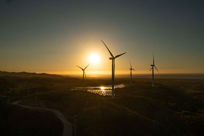Aerial view of group of wind turbines on the coastline at sunset. wind power plant. philippines.