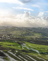 Scenic view of agricultural field against sky