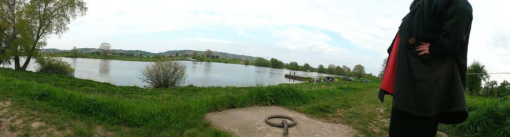 Scenic view of river by trees against sky