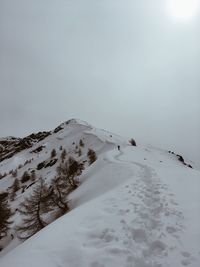 Scenic view of snow covered mountain against sky