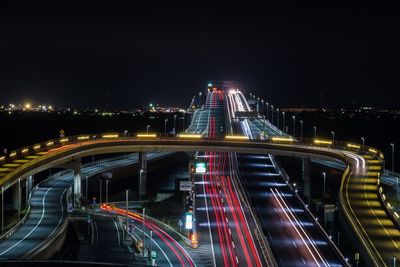 Illuminated roads against sky at night