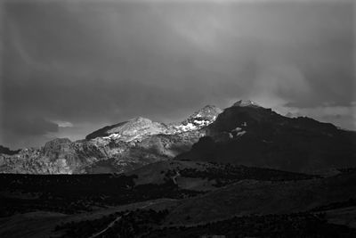 Scenic view of mountains against cloudy sky